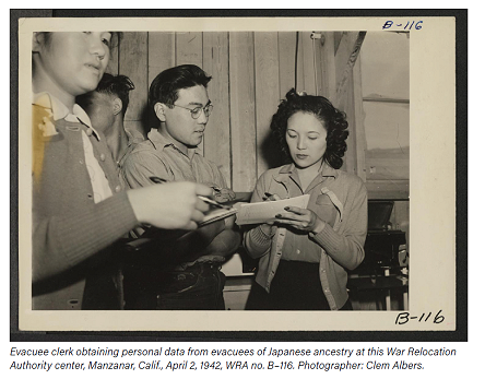 Evacuee clerk obtaining personal data from evacuees of Japanese ancestry at this War Relocation Authority center, Manzanar, Calif., April 2, 1942, WRA no. B116. Photographer: Clem Albers.