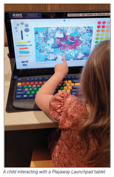 A child interacting with a Playaway Launchpad tablet