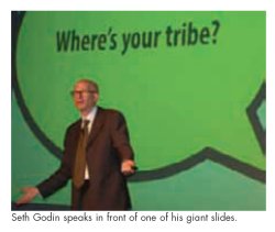 Seth Godin speaks in front of one of his giant slides.