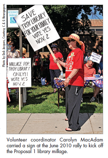 Volunteer coordinator Carolyn MacAdam â€¨carried a sign at the June 2010 rally to kick off the Proposal 1 library millage.