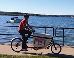 Norte! co-founder Ty Schmidt cruises the Community Library along West Grand Traverse Bay.