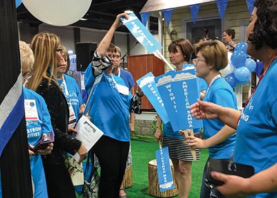 ALA staffers and ALA president Loida Garcia-Febo (in black) hand out signs and prepare for a rally in the exhibit hall.